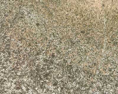 Technician performing concrete sandblasting for a smooth finish.