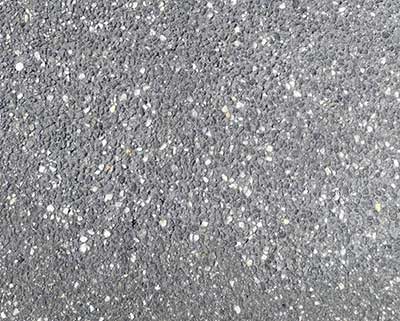 Technician performing mobile sandblasting Melbourne on a concrete surface, achieving a clean and even finish.