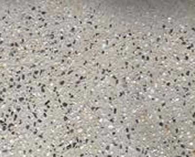 Sandblasting removing paint and grime from a concrete surface.