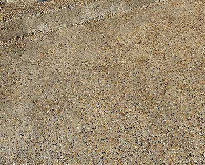 Professional sandblasting cleaning a concrete patio.